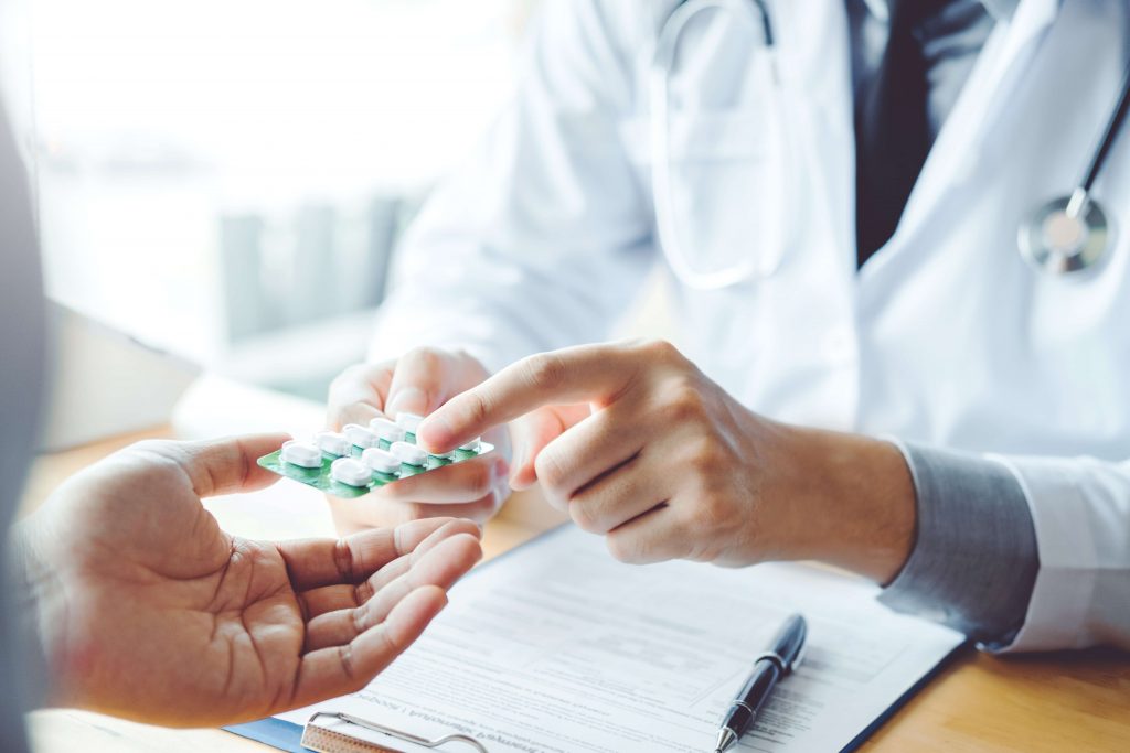 Doctor pointing at pill