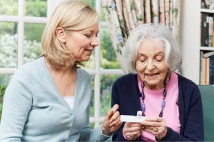 Woman showing senior medication management box