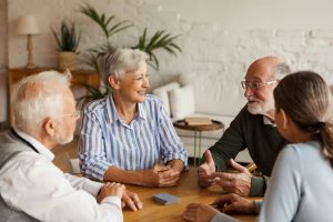 Seniors having a group conversation at a table