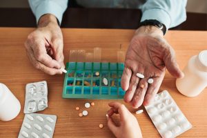 Senior receiving and organizing prescription medication